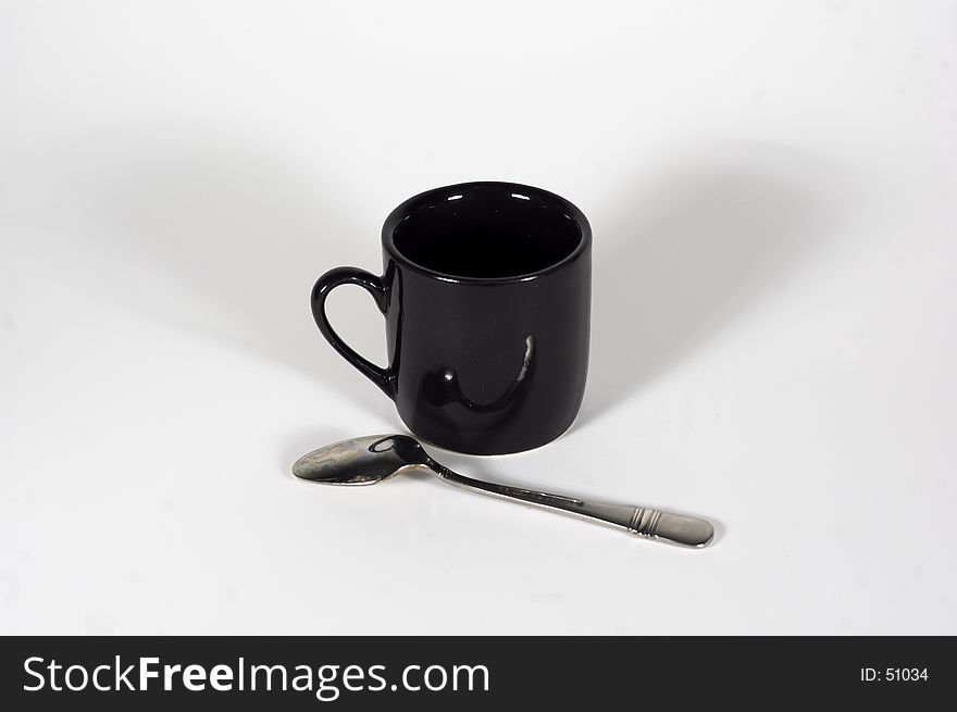 An espresso cup & spoon. An espresso cup & spoon