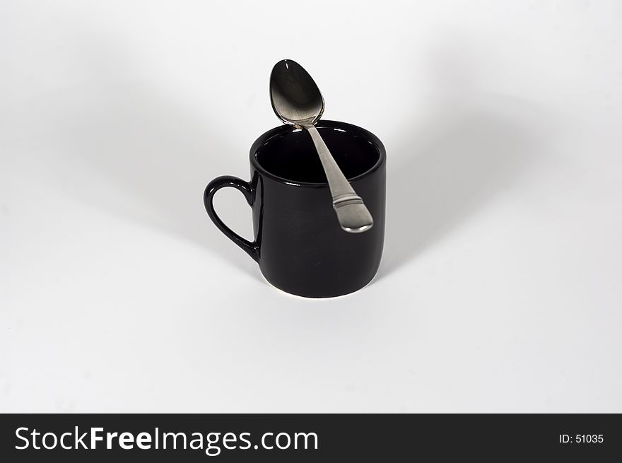 An espresso cup and it's little spoon on it. An espresso cup and it's little spoon on it.