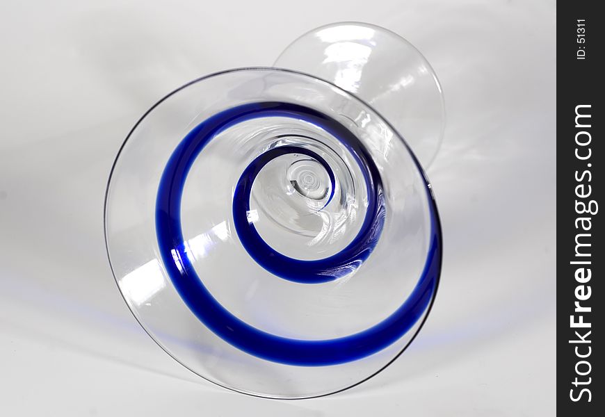 A frontal view of a martini glass with a blue swirl pattern, isolated. A frontal view of a martini glass with a blue swirl pattern, isolated