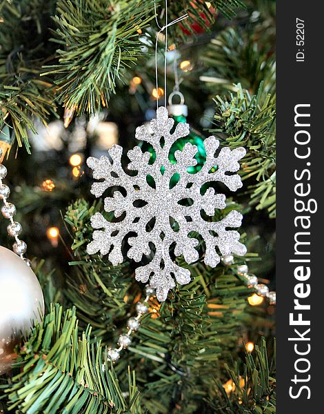 An Christmas tree oranment shaped like a snow flake. An Christmas tree oranment shaped like a snow flake.