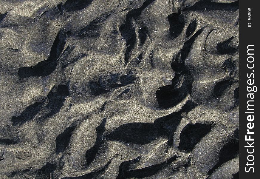 Wet sand in an interesting pattern of ripples and rivulets. Nice for backgrounds and textures. Wet sand in an interesting pattern of ripples and rivulets. Nice for backgrounds and textures.