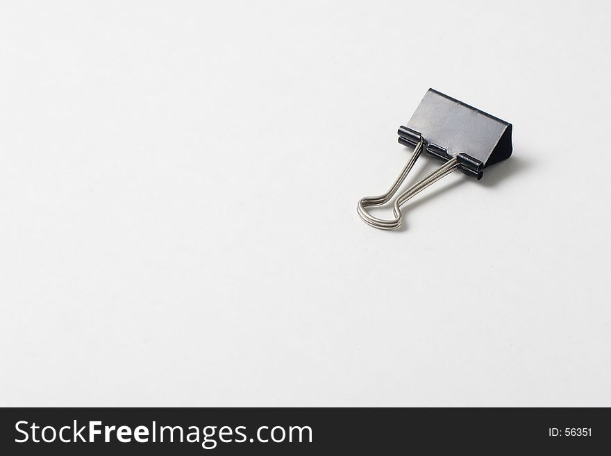 An isolated paper clip on white background. An isolated paper clip on white background