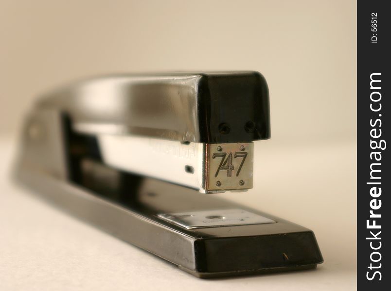 Black and metal stapler. on off white background