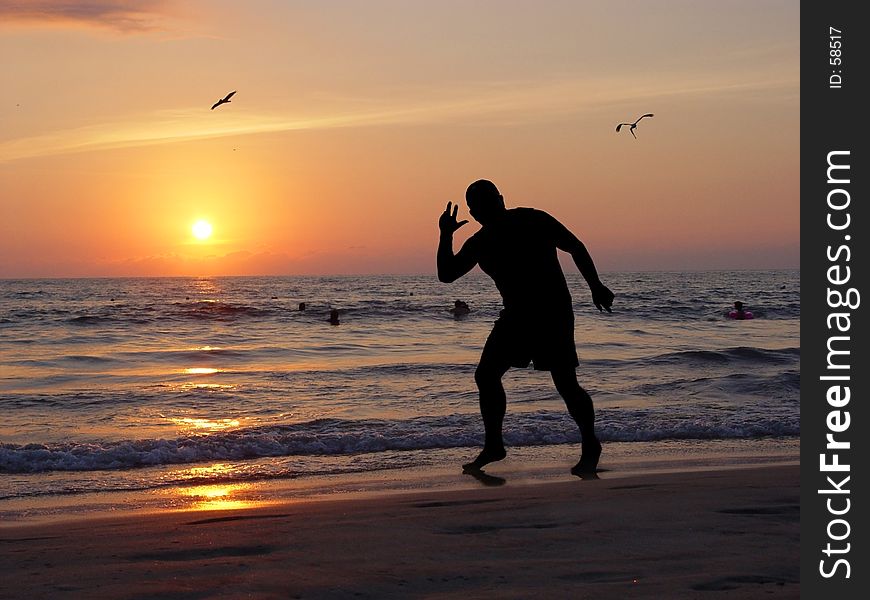 Man silhouette on the beach at sunset. Man silhouette on the beach at sunset