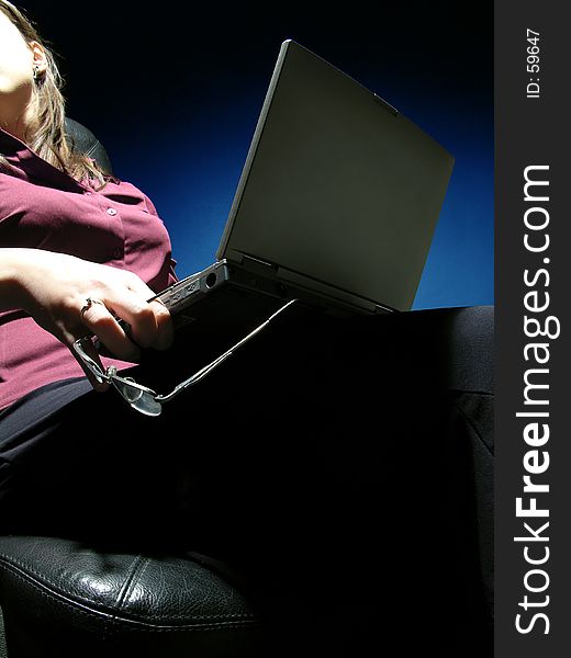 Woman using a laptop and talking with someone over the shoulder. Woman using a laptop and talking with someone over the shoulder.