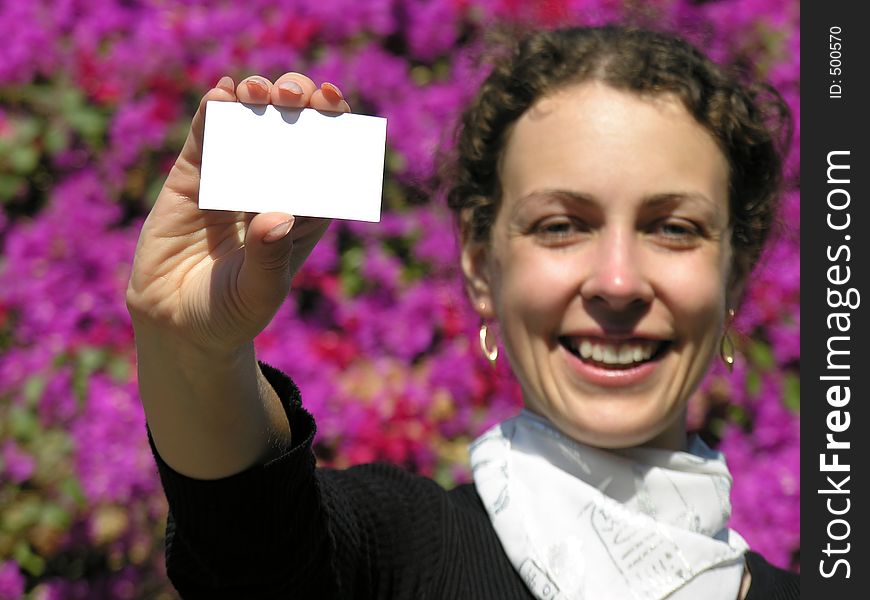 Girl with card for text and flowers