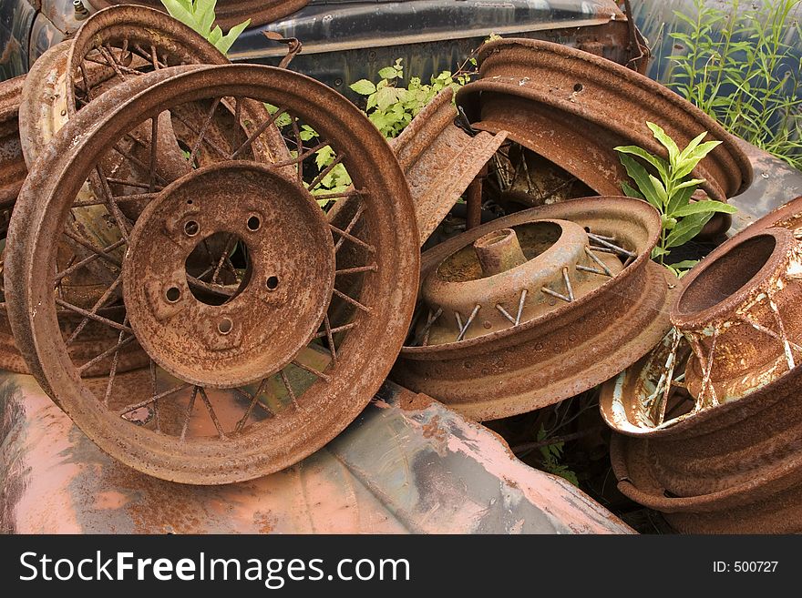 A collection of rusty vintage wheel rims. A collection of rusty vintage wheel rims