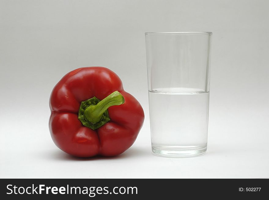 Red paprika and a glass of water. Red paprika and a glass of water.