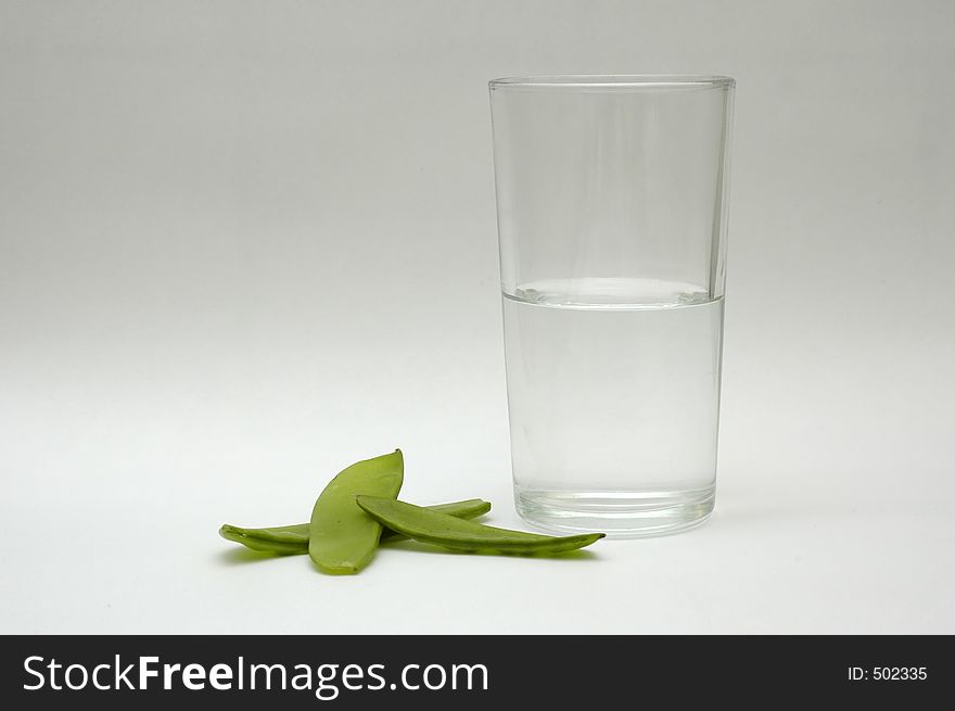 Green vegetable and a glass of water. Green vegetable and a glass of water.