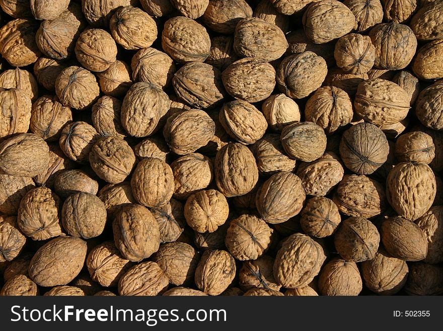 High-res image of many walnuts in a market stand