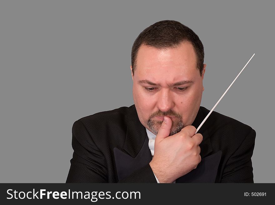 An orchestra conductor, isolated against a white background, studies a score, deep in thought. An orchestra conductor, isolated against a white background, studies a score, deep in thought.