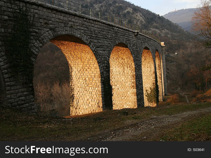 Railroad bridge, illumined with evening sun