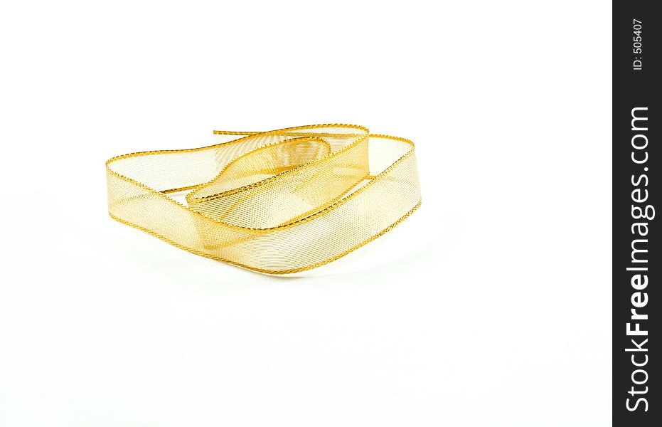 Gold wire mesh ribbon against a white background. Gold wire mesh ribbon against a white background.