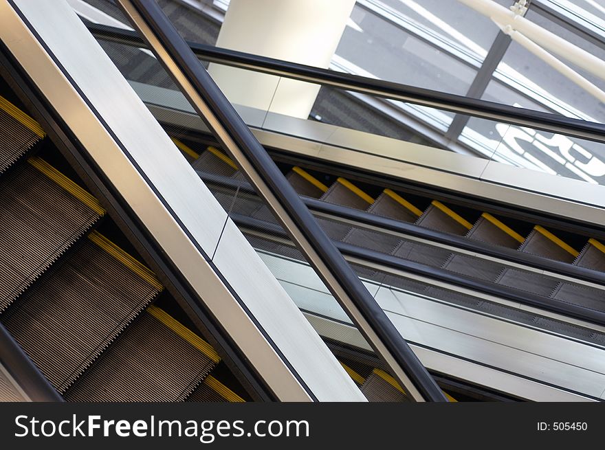 Two escalators cross on a diagonal. Two escalators cross on a diagonal