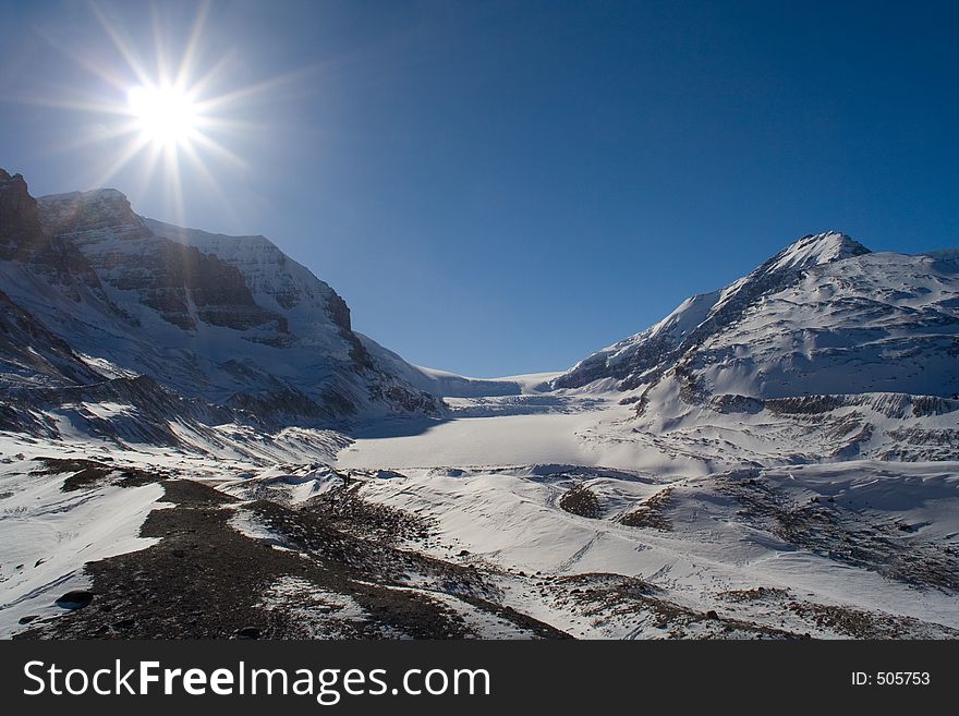 A bright sun breathes light on the Columbia Icefields in winter.