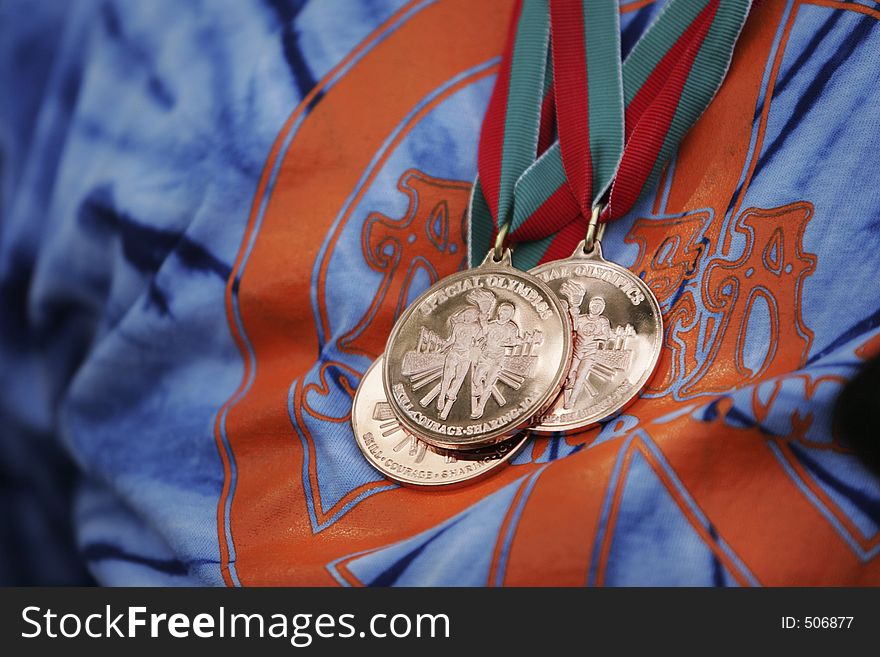 Winning gold medals on a blue and orange t-shirt. Winning gold medals on a blue and orange t-shirt