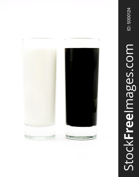 Isolated photo of glasses of black and white liquids