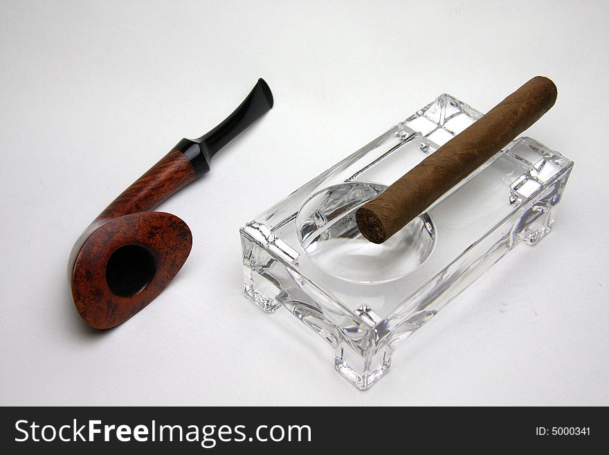 Tobacco pipes and cigar isolated on white. Tobacco pipes and cigar isolated on white.