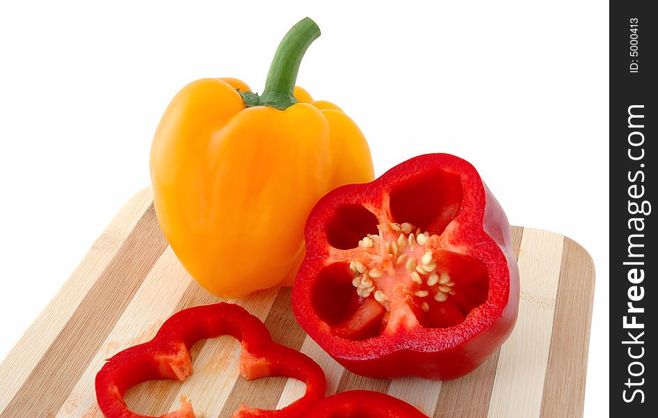 Red and yellow paprika on bamboo cutting board. Red and yellow paprika on bamboo cutting board