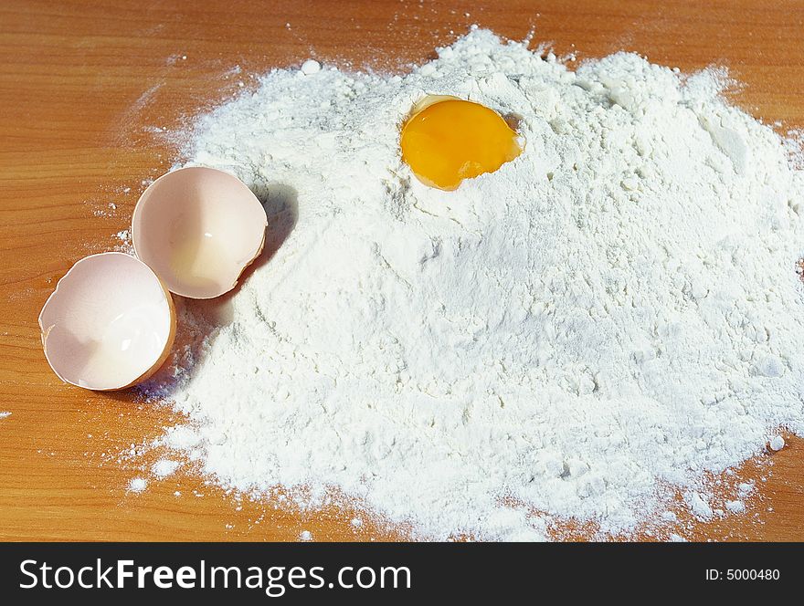 Flour, egg and shell on a table in kitchen