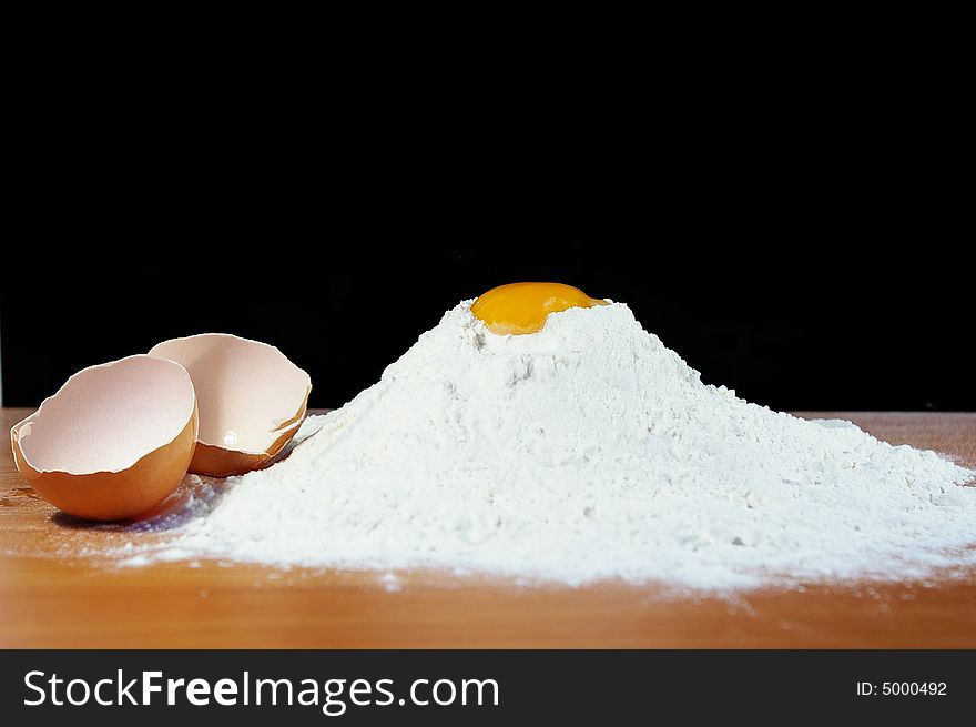 Flour, egg and shell on a table in kitchen