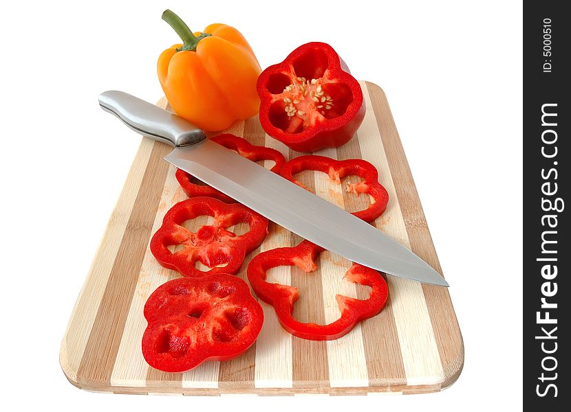 Red and yellow paprika on bamboo cutting board. Red and yellow paprika on bamboo cutting board