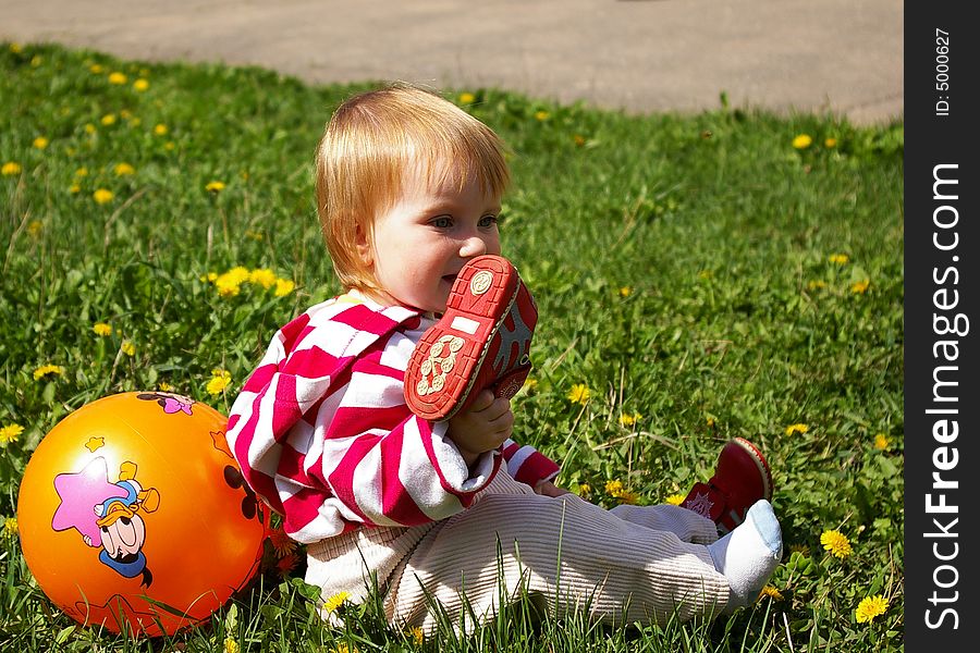 Girl with ball on  grass