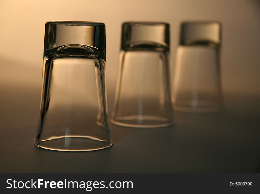 Three empty alcohol glasses, distance blur. Three empty alcohol glasses, distance blur