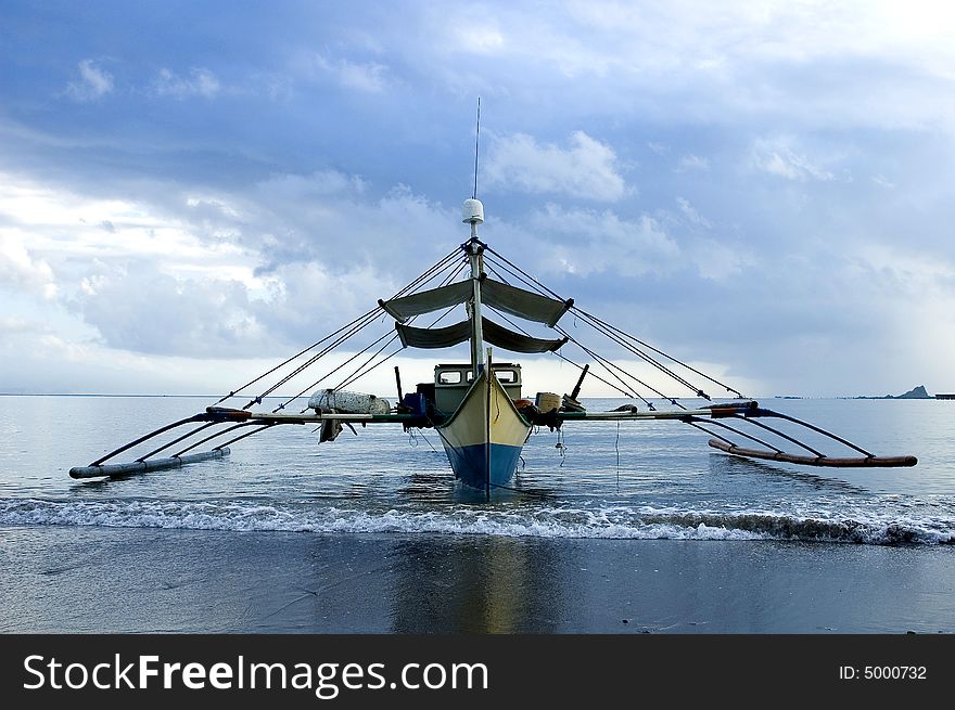 A traditional fishing boat anchored near the shore.