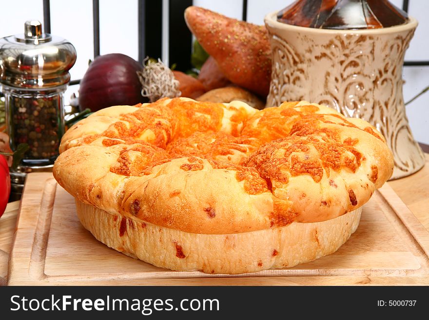 Fresh baked cheddar cheese roll loaf in kitchen or restaurant setting. Fresh baked cheddar cheese roll loaf in kitchen or restaurant setting.