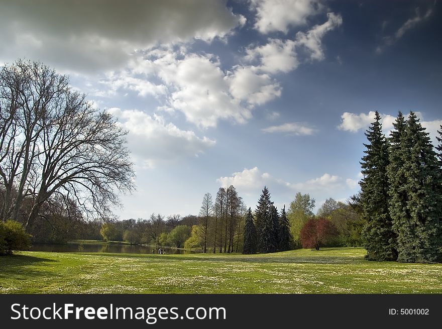 Spring landscape with trees and stormy clouds