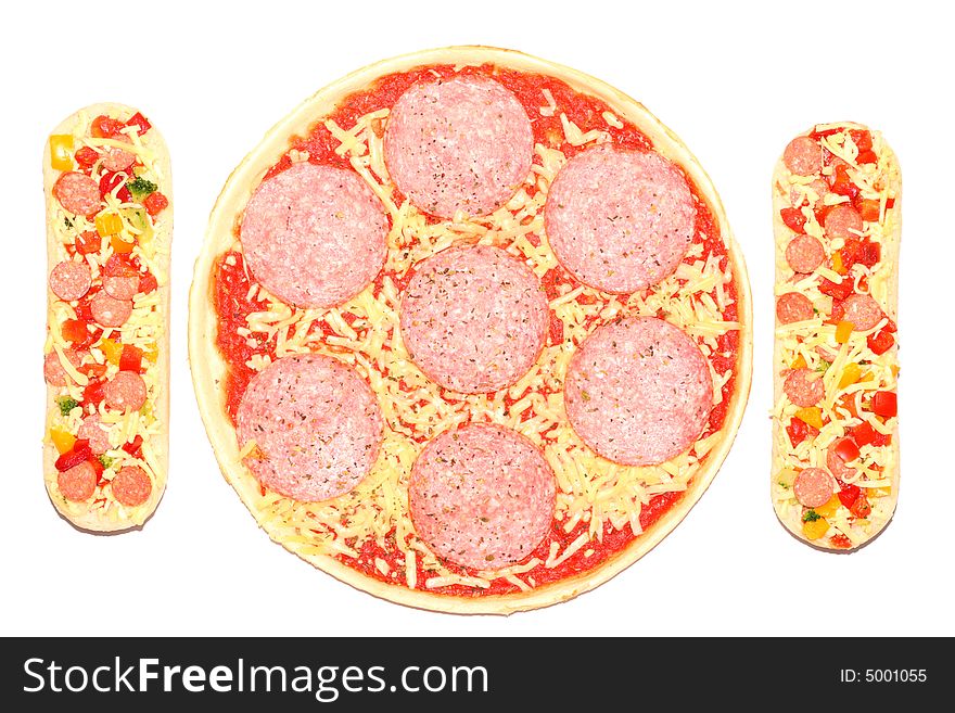 Uncooked, frozen pizza and baguettes isolated on a white background. Uncooked, frozen pizza and baguettes isolated on a white background.