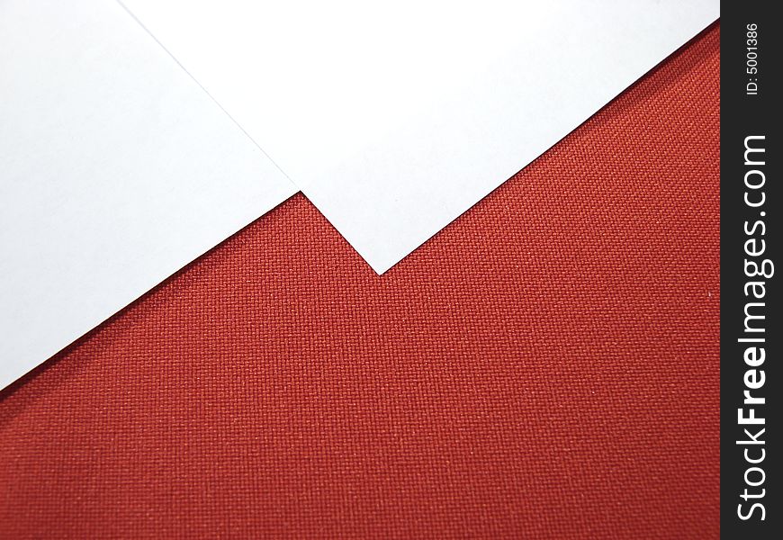 White paper sheets on red background