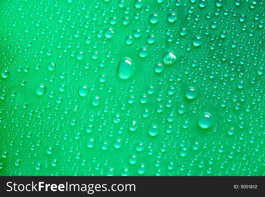 Drops on a green  textured Plastic foil