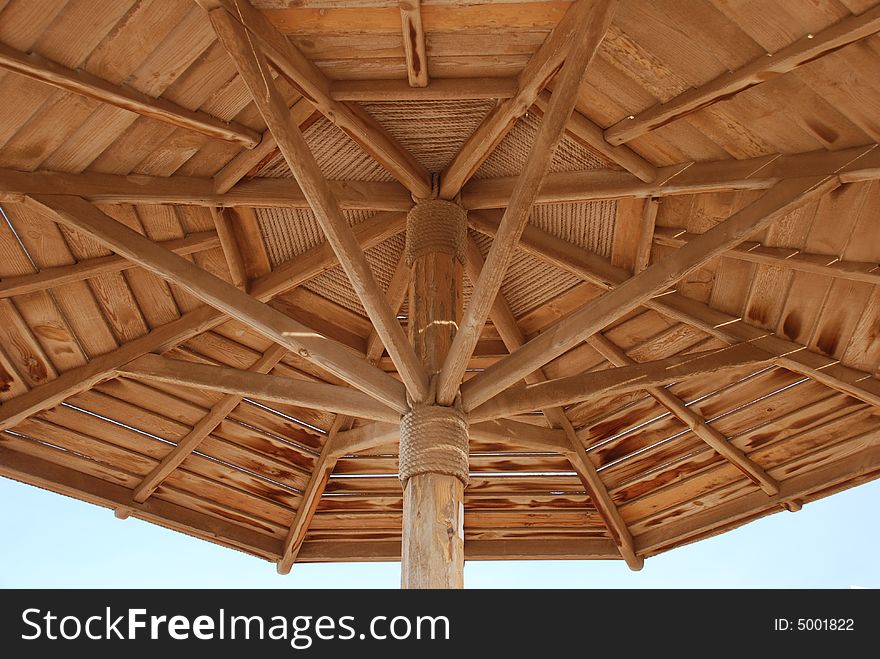 Beach umbrella on the blue sky background