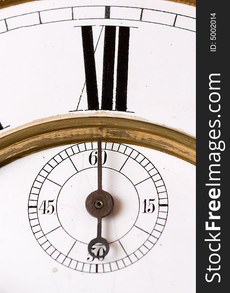 Old clock face detail with roman numerals - focus on the second hand. Old clock face detail with roman numerals - focus on the second hand.