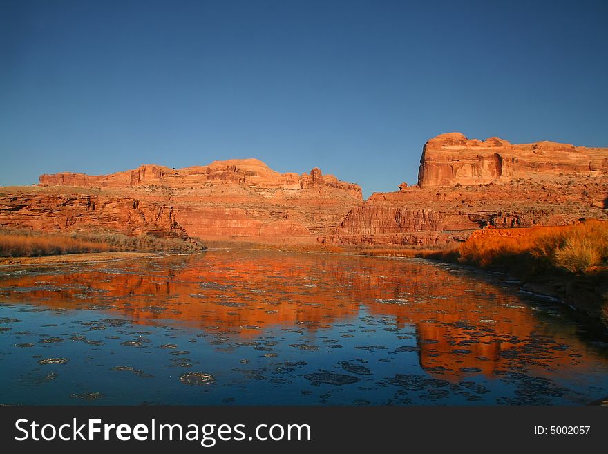 Red rock reflections on the Colorado River with Blue skyï¿½s. Red rock reflections on the Colorado River with Blue skyï¿½s