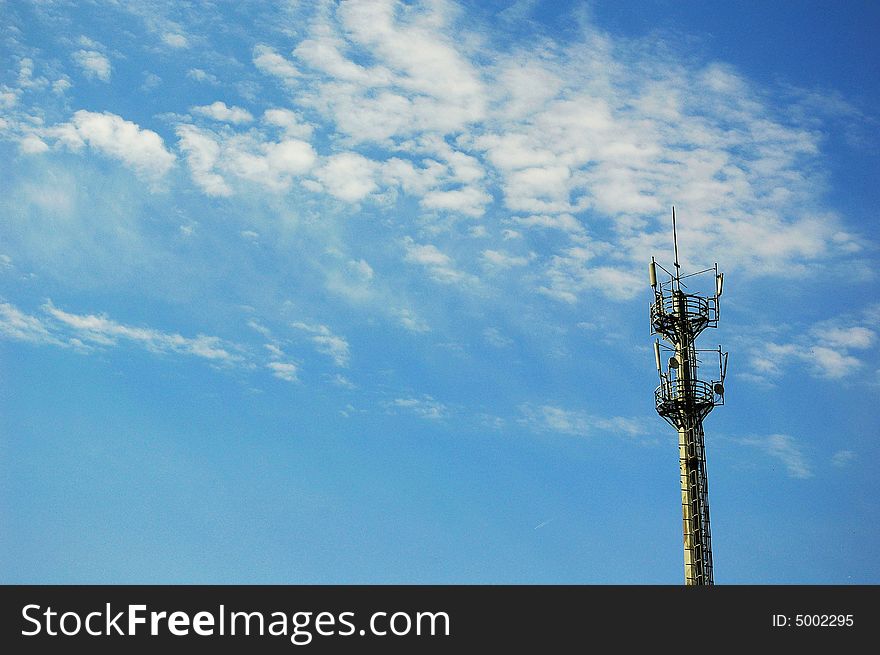 Telecommunication mast on blue sky