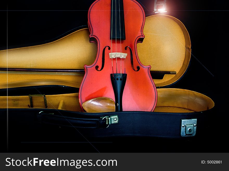 Antique violin with some chalk on a black backgound