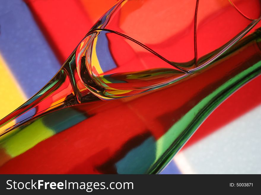 Abstract background design made from numerous colors and a bottle and glass.
