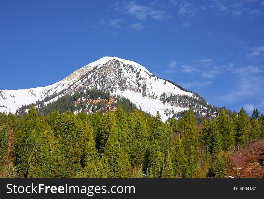 Large mountain with snow on it in the spring. Large mountain with snow on it in the spring
