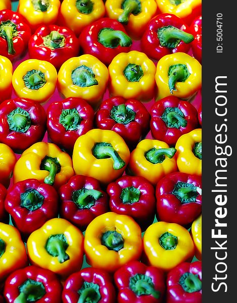 Fresh red and yellow pepper lay out in order