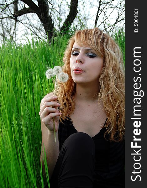 Young girl with a dandelion