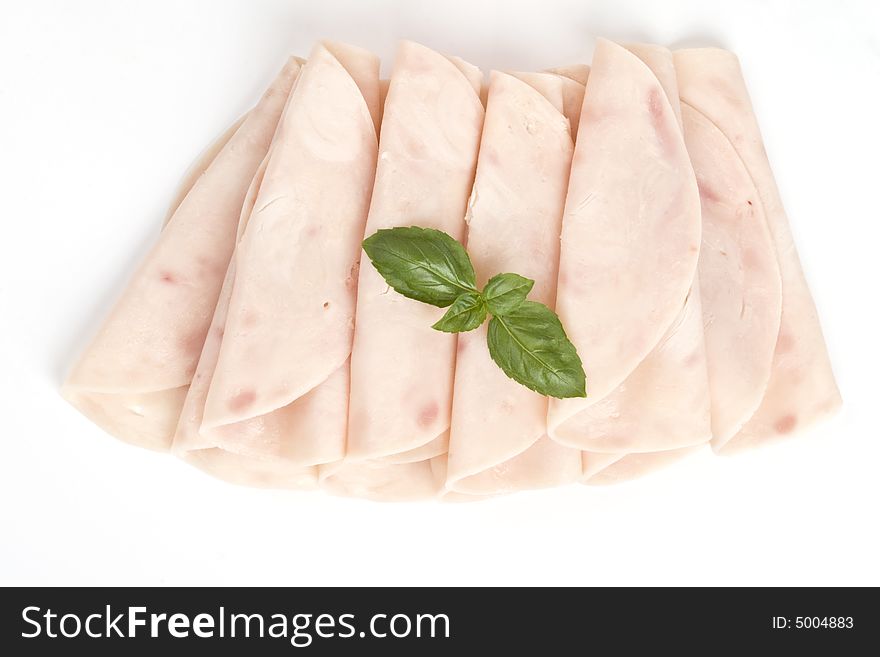 Slices of ham with basil