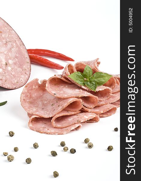 Salame and slices of salame with herbs. Salame and slices of salame with herbs