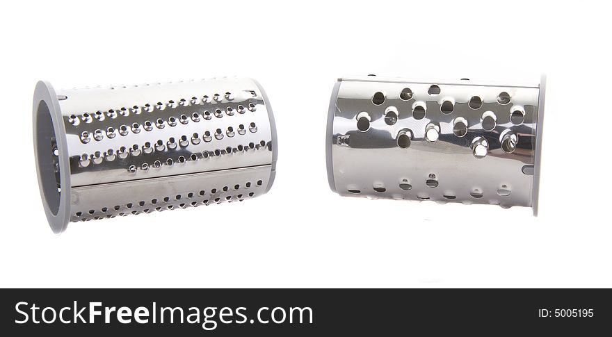 Two chrome attachments for a food processor on a white background. Two chrome attachments for a food processor on a white background
