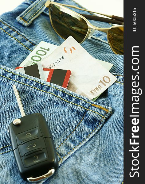Conceptual shot Ready to travel with jeans, money, credit cards and car key