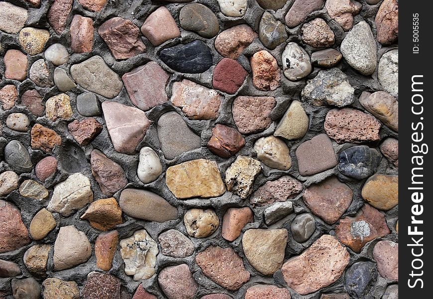 Small stones in a wall background. Small stones in a wall background