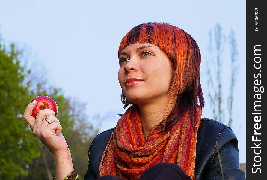 The beautiful young girl and red apple