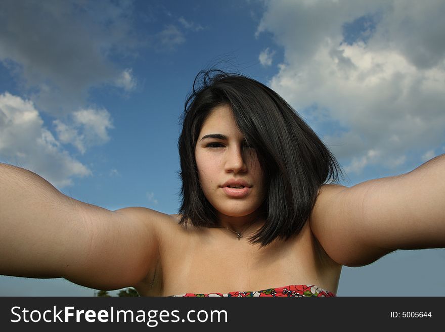 Woman with her arms extended beyond the camera. Woman with her arms extended beyond the camera